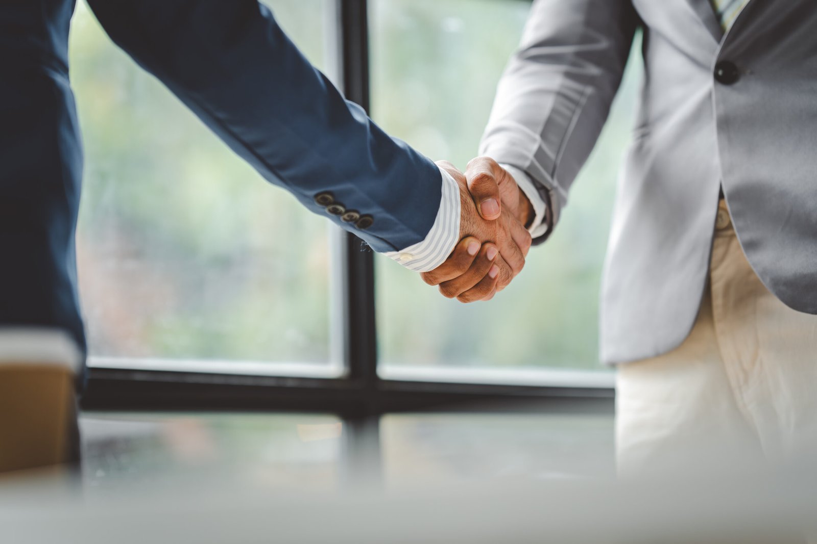 Two professionals shaking hands to mark a business partnership
